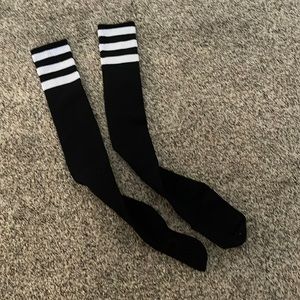 Thigh high black socks with white stripes. Like new.